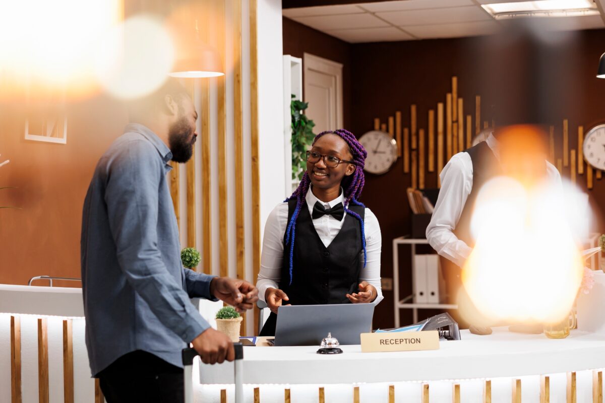 Hotel receptionist talking with guest