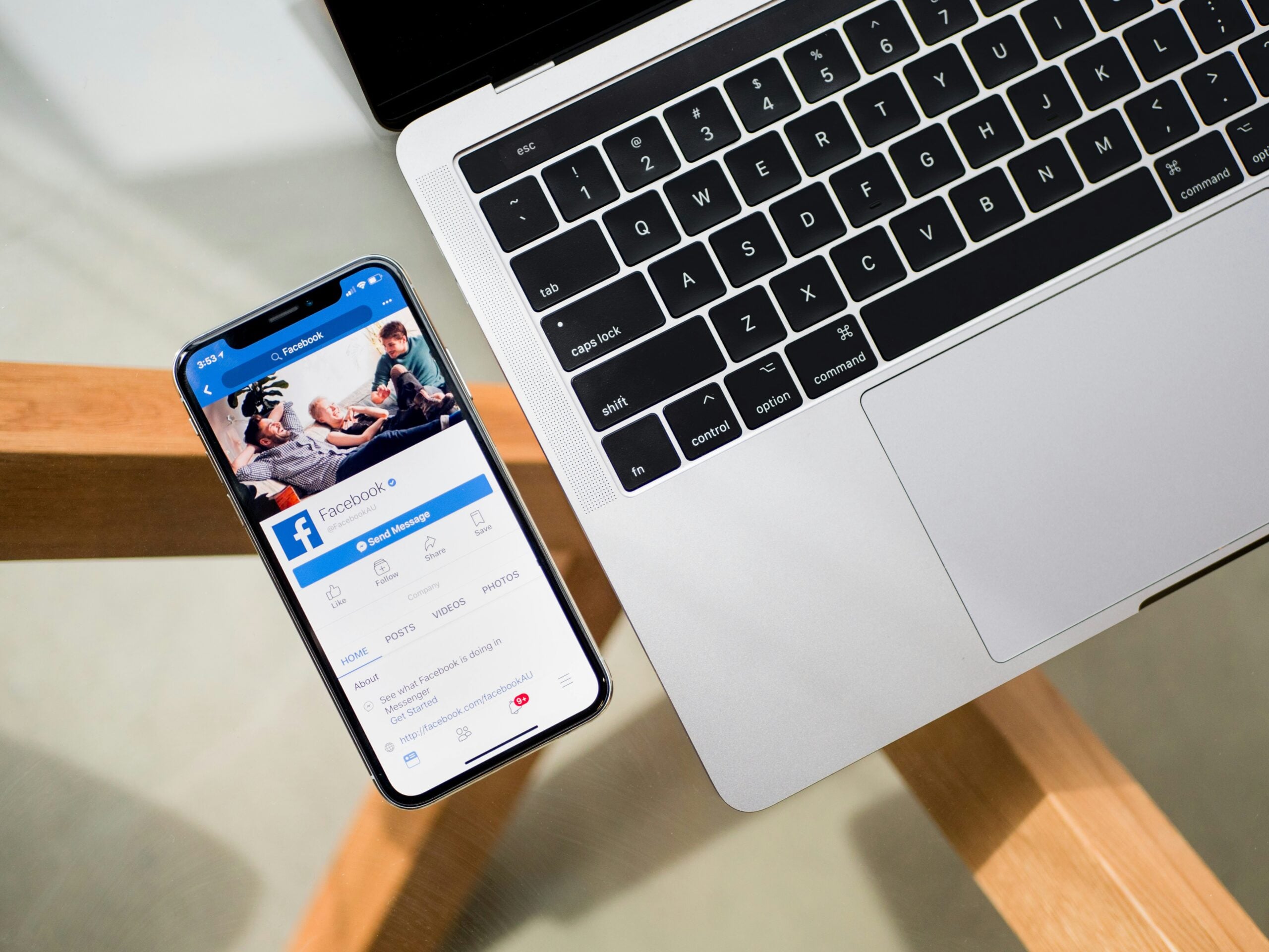 Laptop and iPhone displaying Facebook, illustrating social media management and advertising.