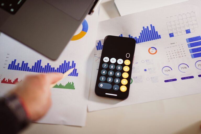 Marketing agency cost analysis with charts, calculator, and laptop