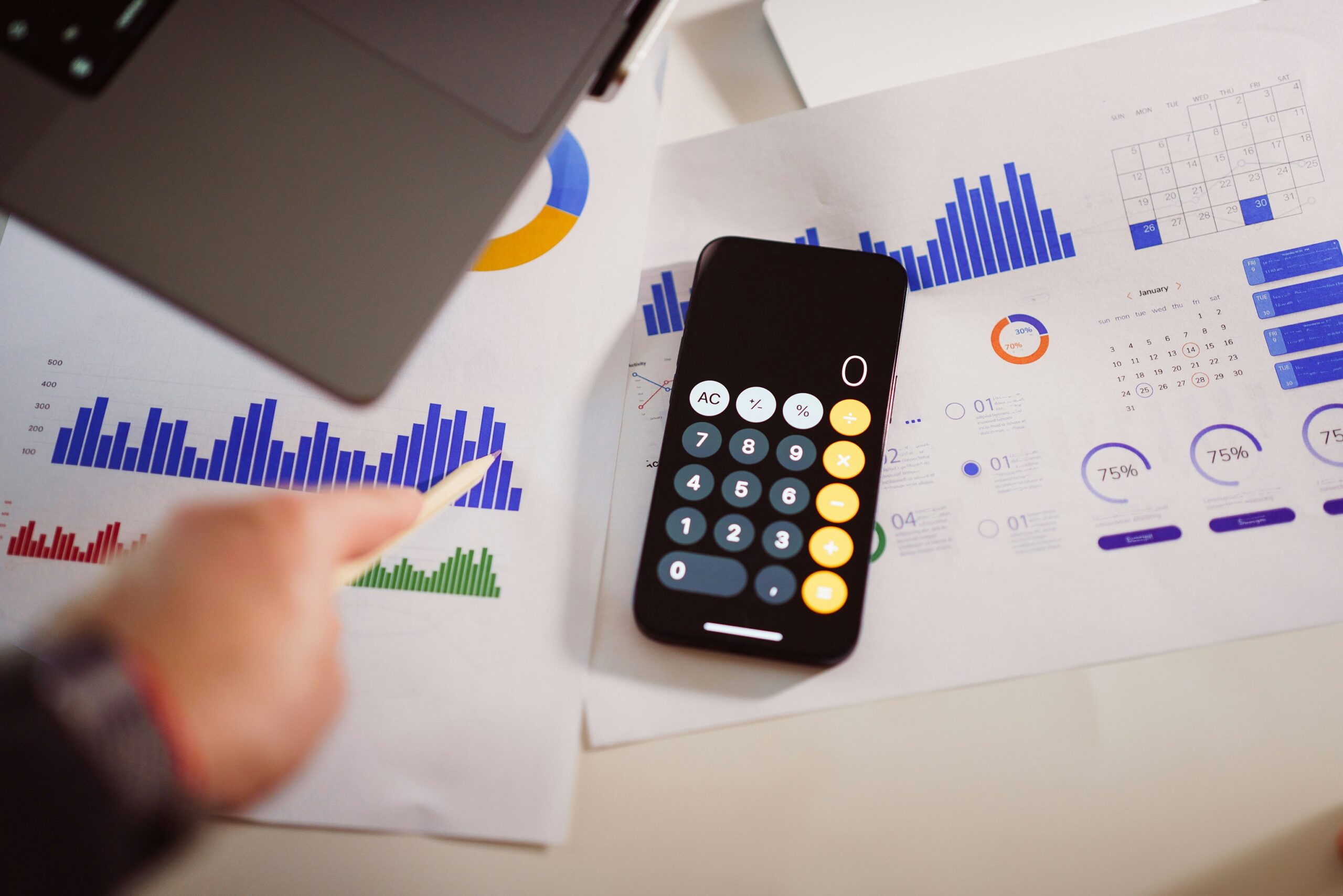 Marketing agency cost analysis with charts, calculator, and laptop