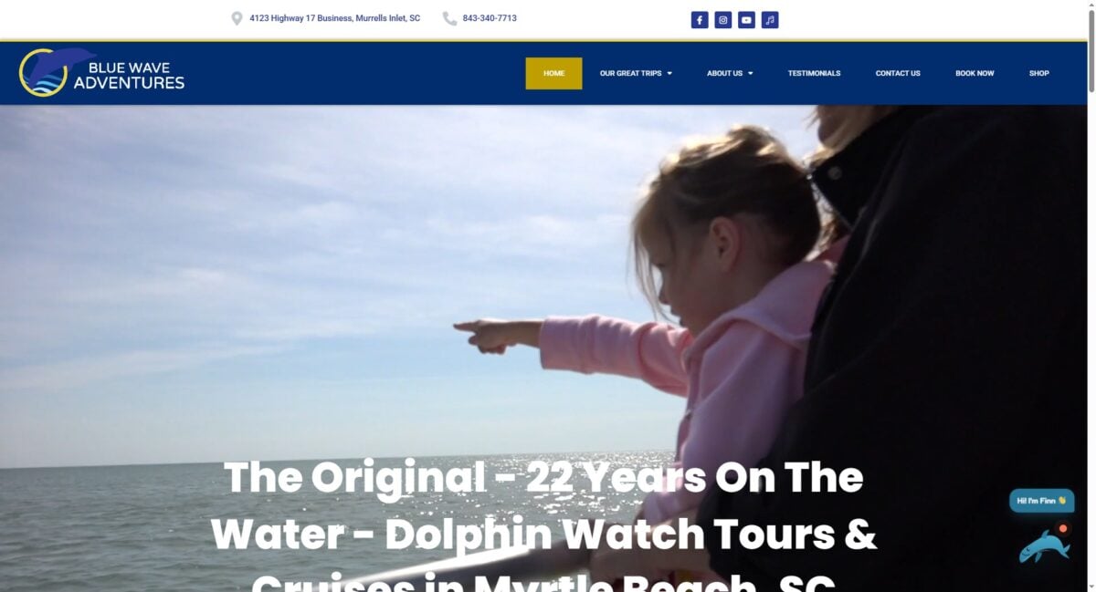 Girl points at dolphins on a Blue Wave Adventures boat tour