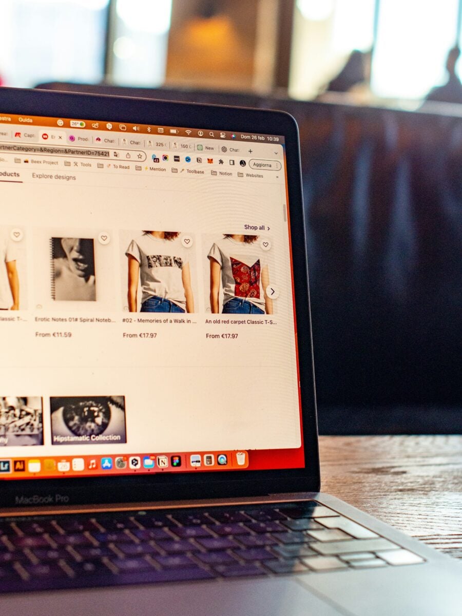 Laptop displaying online store with t-shirts, promoting conversion rate optimization services.