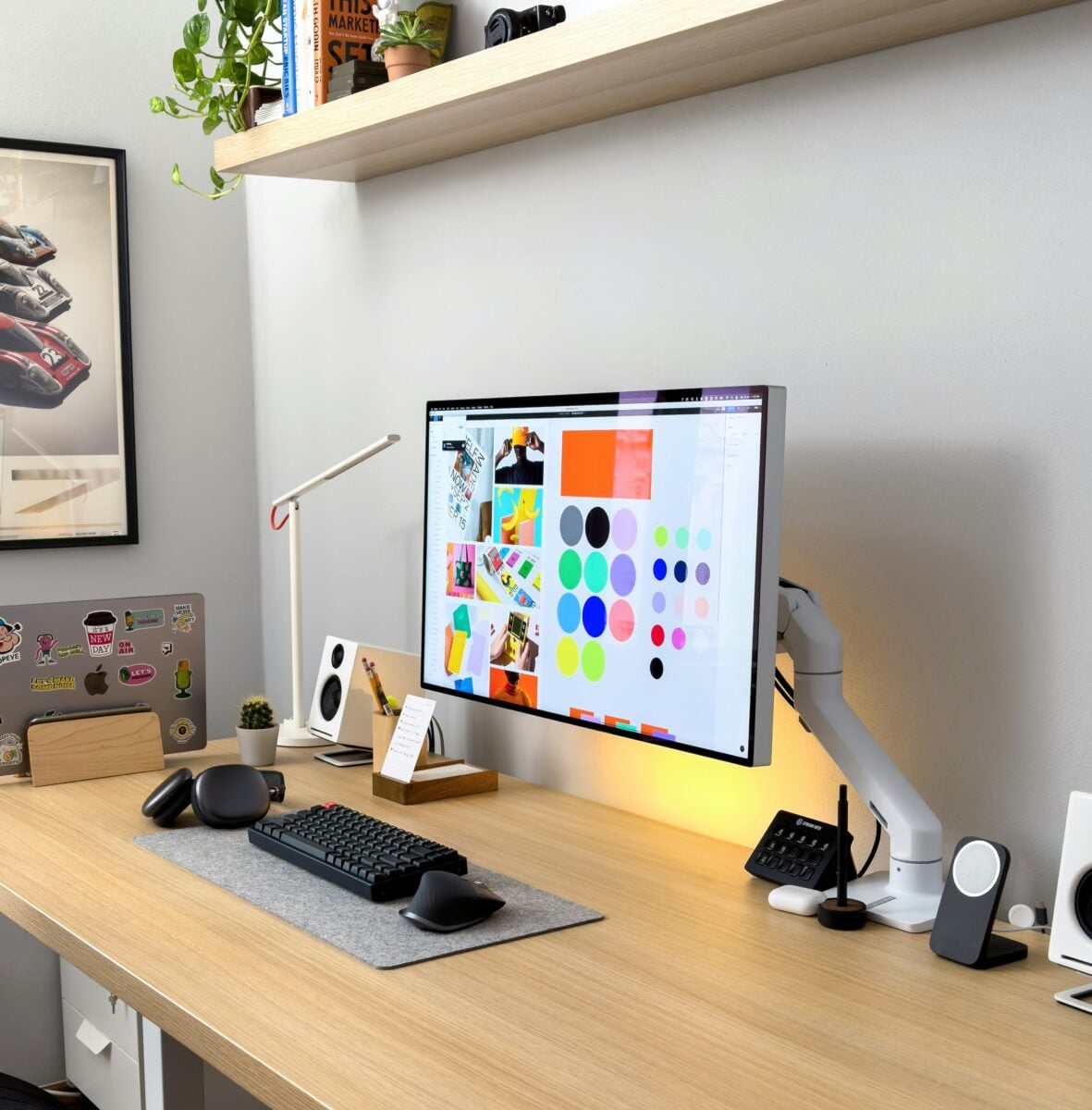 Modern desk setup with computer monitor displaying design software, relevant to branding and identity design.