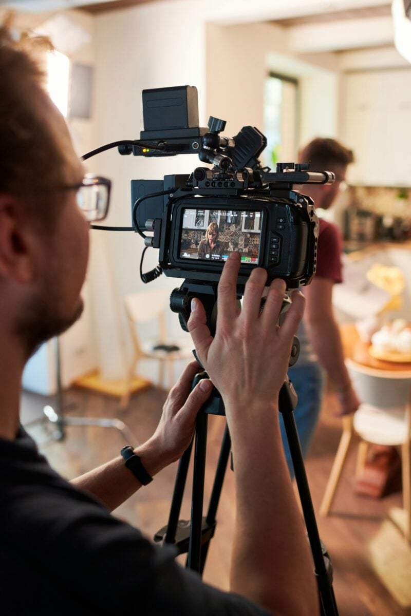 Filming a scene with a professional video camera on a tripod, video production